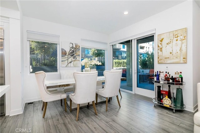 dining room featuring recessed lighting, baseboards, and wood finished floors