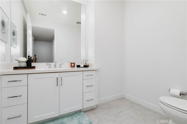 bathroom featuring visible vents, baseboards, toilet, tile patterned floors, and vanity