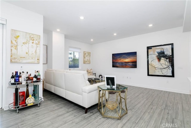 living room with recessed lighting, wood finished floors, and baseboards