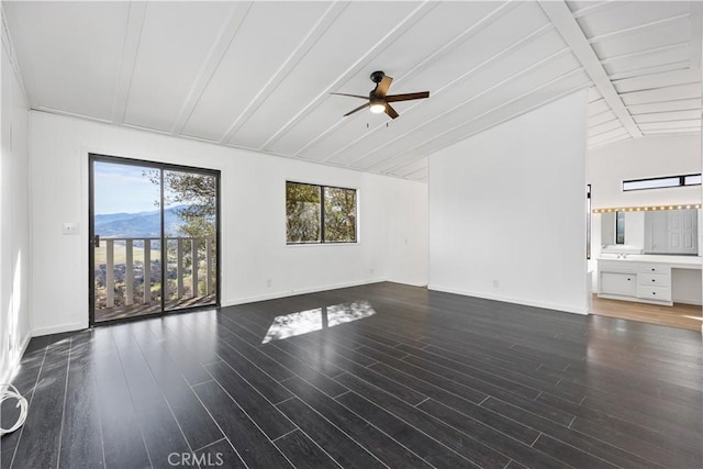 unfurnished living room with a ceiling fan, lofted ceiling with beams, baseboards, and wood finished floors