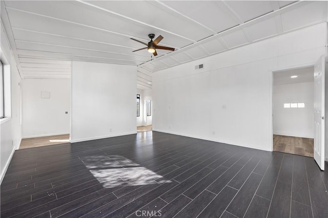 unfurnished room featuring lofted ceiling, a wealth of natural light, wood finished floors, and a ceiling fan