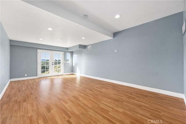 empty room with french doors, recessed lighting, visible vents, light wood-style flooring, and baseboards