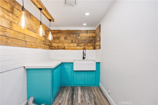 interior space with recessed lighting, wood finished floors, a sink, baseboards, and tasteful backsplash