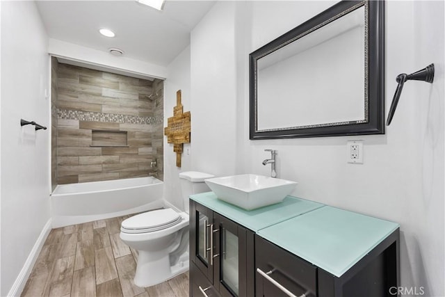 bathroom featuring wood finish floors, recessed lighting, toilet, vanity, and baseboards