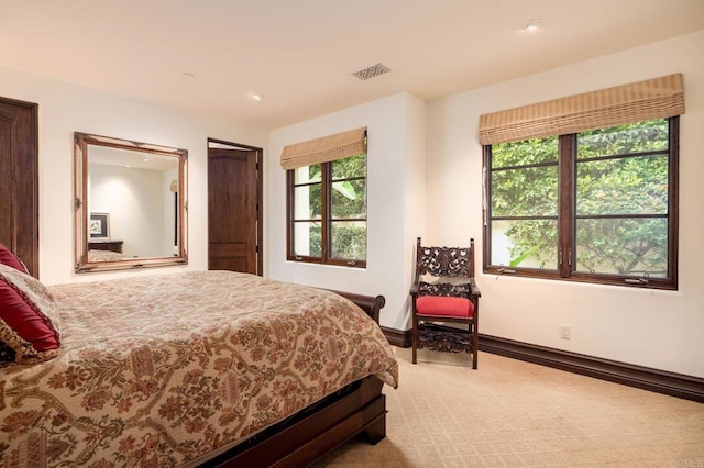 bedroom with carpet floors, visible vents, and baseboards