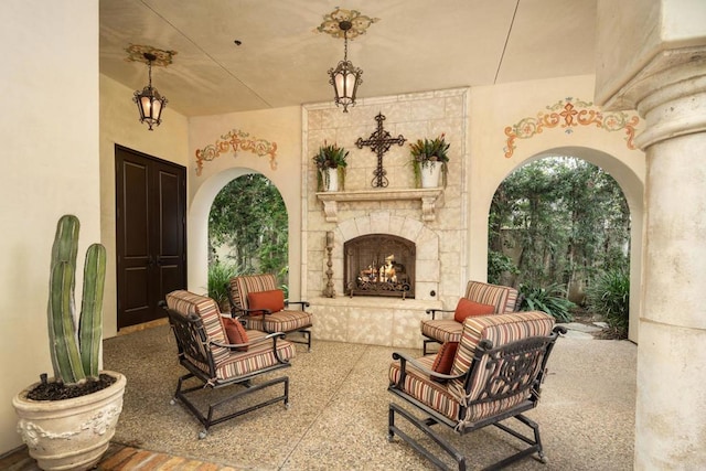 view of patio / terrace featuring an outdoor stone fireplace