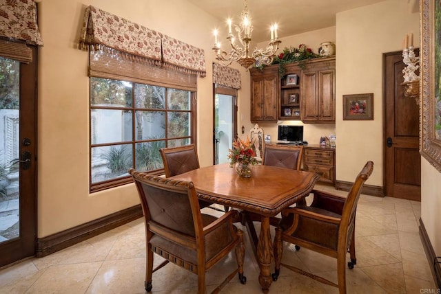 dining area featuring a healthy amount of sunlight, an inviting chandelier, light tile patterned floors, and baseboards