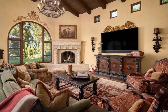 living area with a fireplace, wood finished floors, wood ceiling, beamed ceiling, and an inviting chandelier