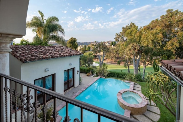 view of pool with a pool with connected hot tub