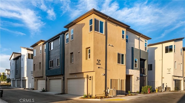 view of property featuring a garage and a residential view