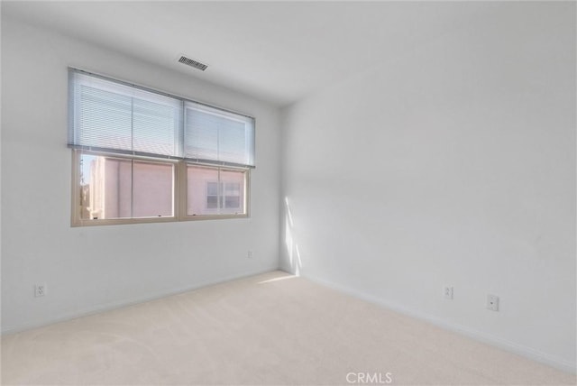 unfurnished room with visible vents and carpet flooring