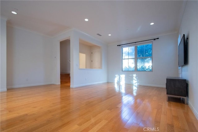 unfurnished living room featuring baseboards, ornamental molding, recessed lighting, and light wood-style floors