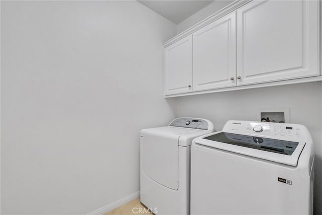 laundry area with cabinet space, baseboards, and separate washer and dryer