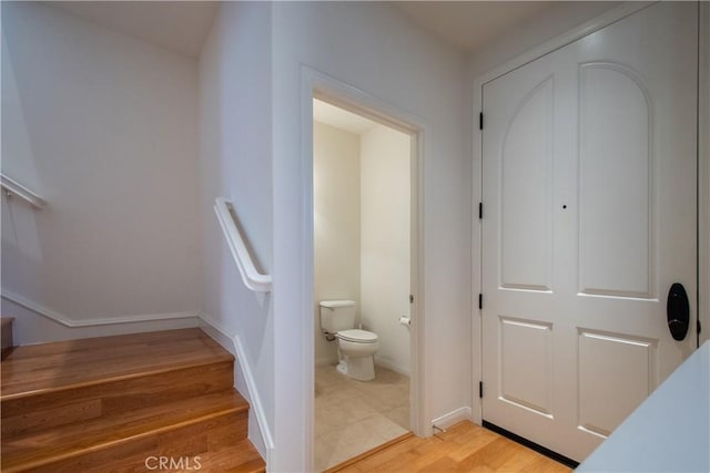 interior space featuring toilet, baseboards, and wood finished floors