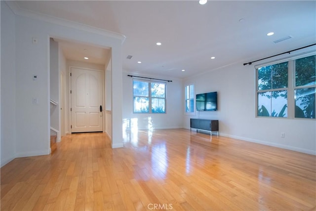 unfurnished living room with baseboards, ornamental molding, light wood-style flooring, and recessed lighting