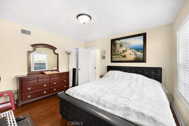 bedroom featuring dark wood-style flooring and visible vents