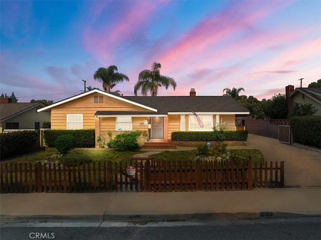 ranch-style house with a fenced front yard