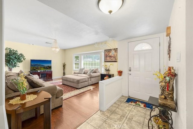 entrance foyer with light wood-style floors, baseboards, and visible vents