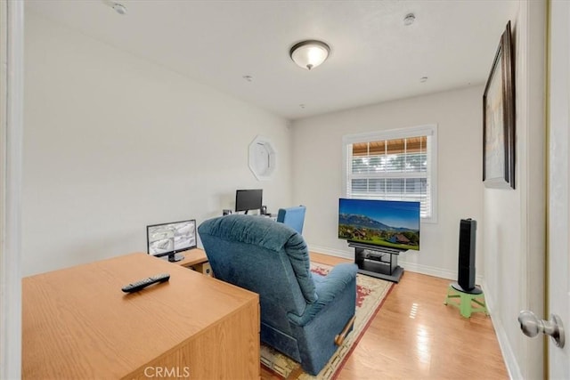 office space featuring baseboards and wood finished floors