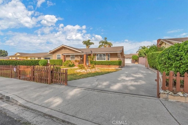 ranch-style house featuring a fenced front yard and a gate