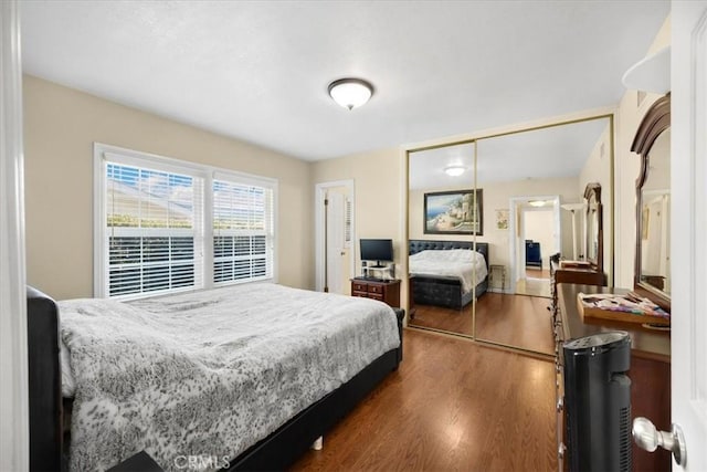 bedroom featuring a closet and dark wood finished floors