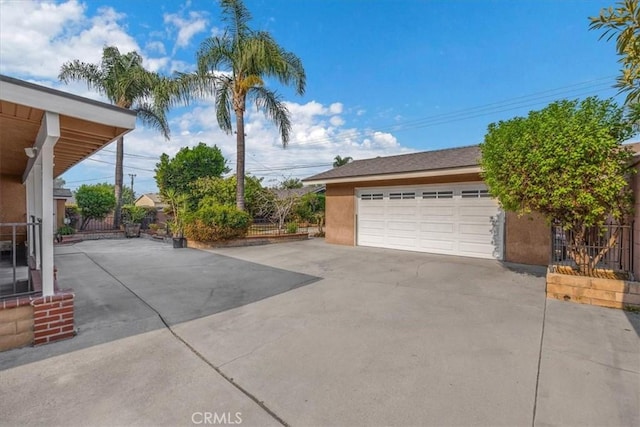 detached garage featuring fence