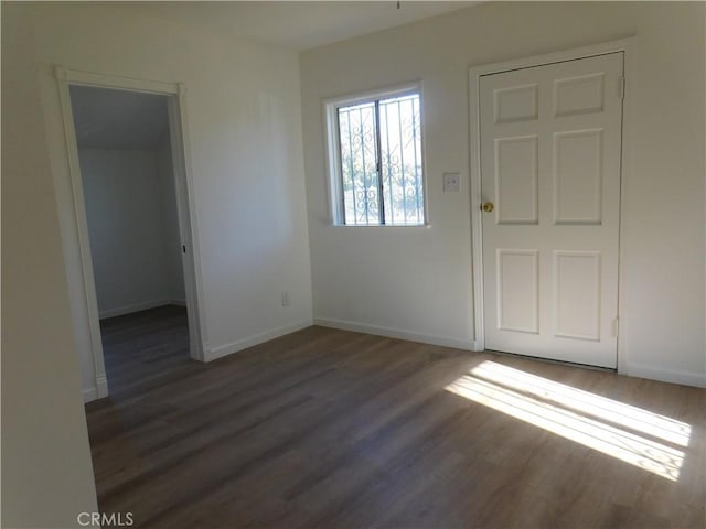 interior space with wood finished floors and baseboards