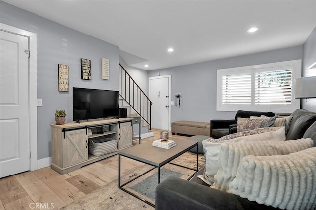 living room featuring recessed lighting, light wood-type flooring, stairs, and baseboards