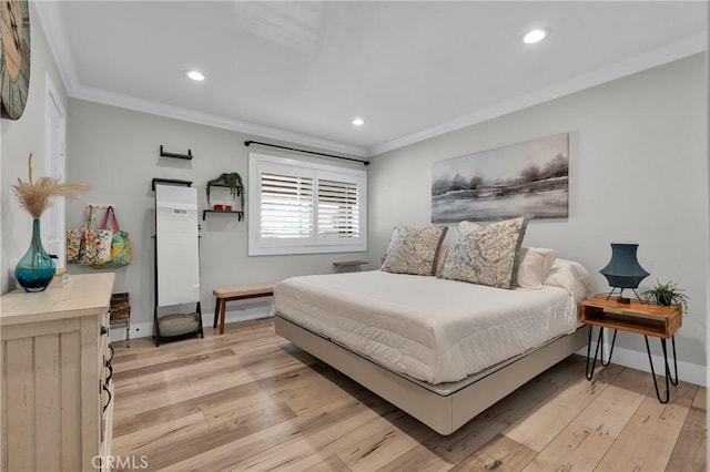 bedroom featuring baseboards, light wood-style floors, and ornamental molding