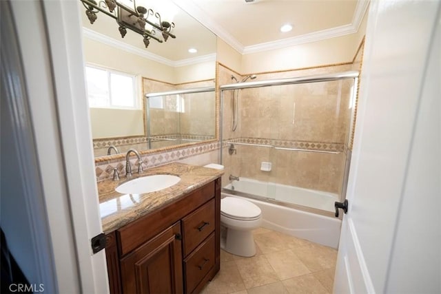 full bath with tile patterned flooring, crown molding, toilet, shower / bath combination with glass door, and vanity