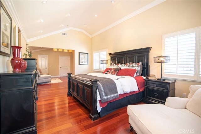 bedroom featuring visible vents, ornamental molding, wood finished floors, baseboards, and lofted ceiling