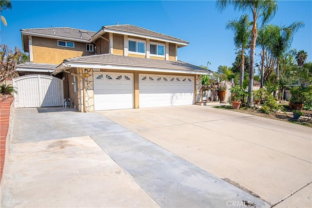 view of front facade featuring stucco siding, driveway, a gate, stone siding, and an attached garage