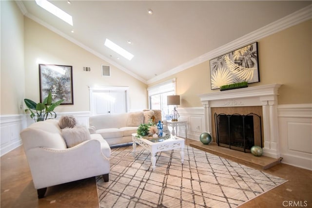 living room with visible vents, a fireplace with raised hearth, a skylight, and a decorative wall