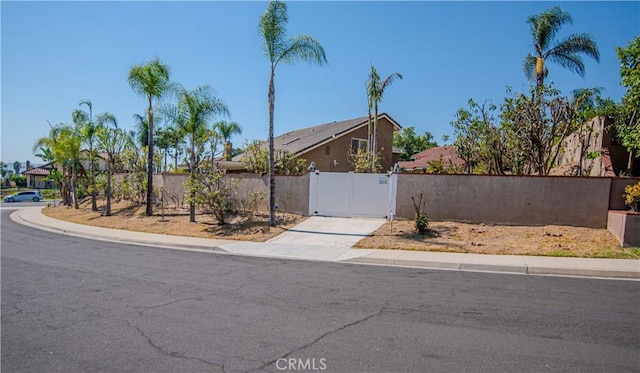 mid-century modern home featuring a fenced front yard and a gate