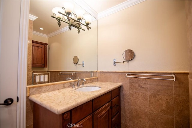 bathroom featuring vanity, crown molding, tile walls, and a wainscoted wall