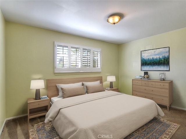 bedroom featuring carpet and baseboards