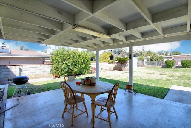 view of patio with outdoor dining area, a fenced backyard, and a grill