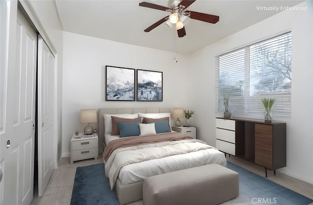 bedroom featuring a closet, baseboards, and a ceiling fan