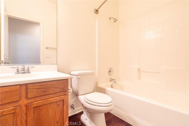 full bath featuring washtub / shower combination, toilet, wood finished floors, and vanity