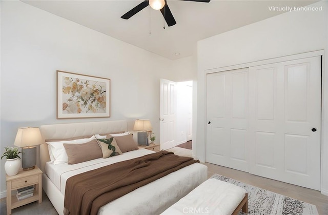 bedroom with a closet, a ceiling fan, and light wood finished floors