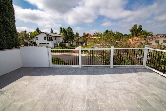 view of gate with a residential view and fence