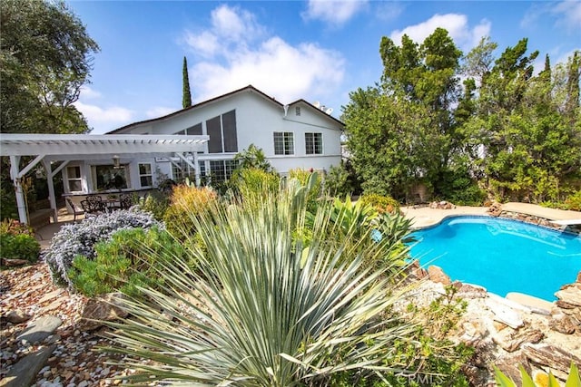 outdoor pool with a pergola and a patio