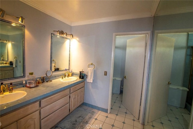 full bathroom with crown molding, a sink, toilet, and double vanity