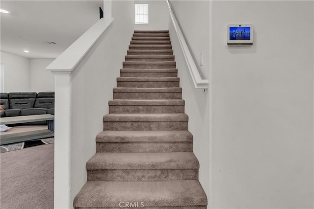 stairway with recessed lighting, visible vents, and carpet floors