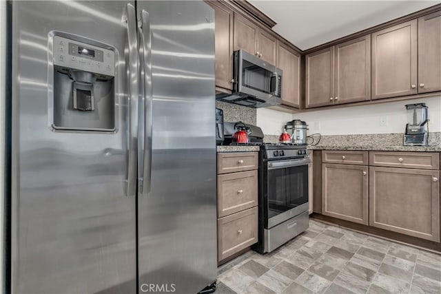 kitchen featuring light stone counters and appliances with stainless steel finishes