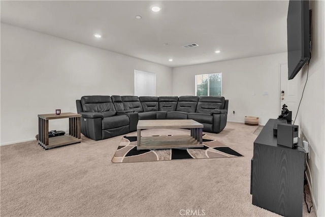 living room with recessed lighting, visible vents, and carpet floors