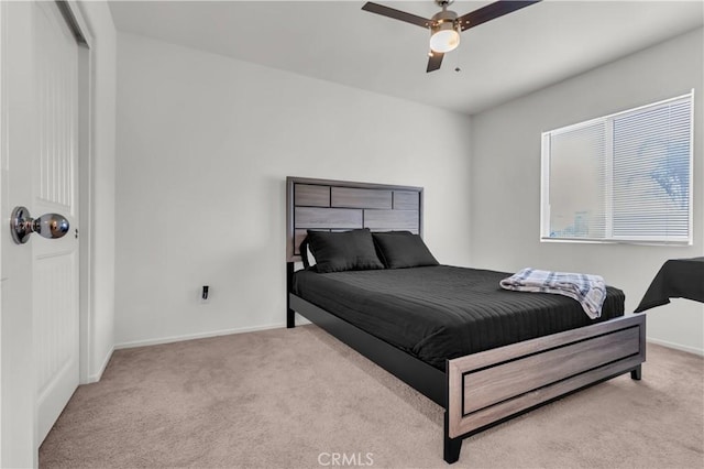 carpeted bedroom with baseboards and ceiling fan