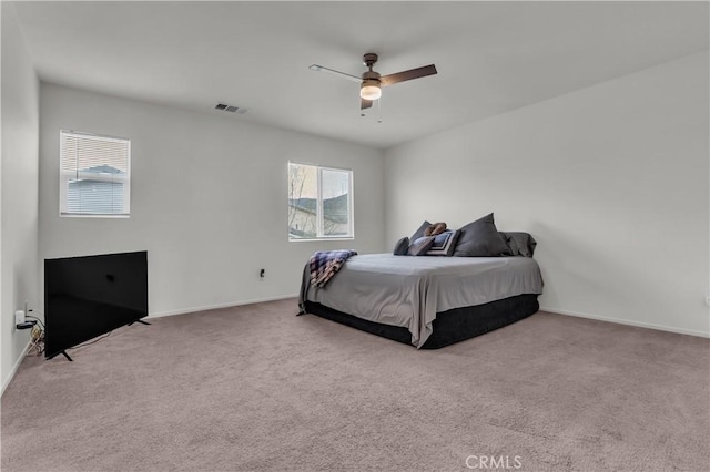 carpeted bedroom with visible vents, ceiling fan, and baseboards