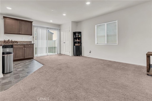 unfurnished living room with recessed lighting and light colored carpet