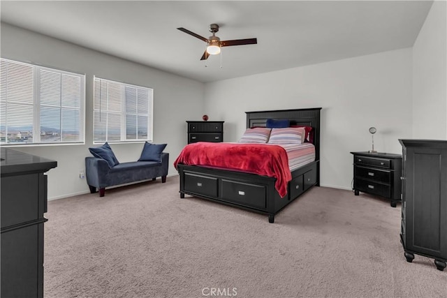 bedroom featuring light colored carpet, baseboards, and ceiling fan